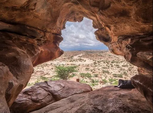 A rock arch opening onto the desert plateau